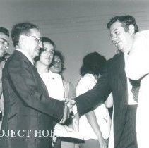Dr William B Walsh shaking hands.